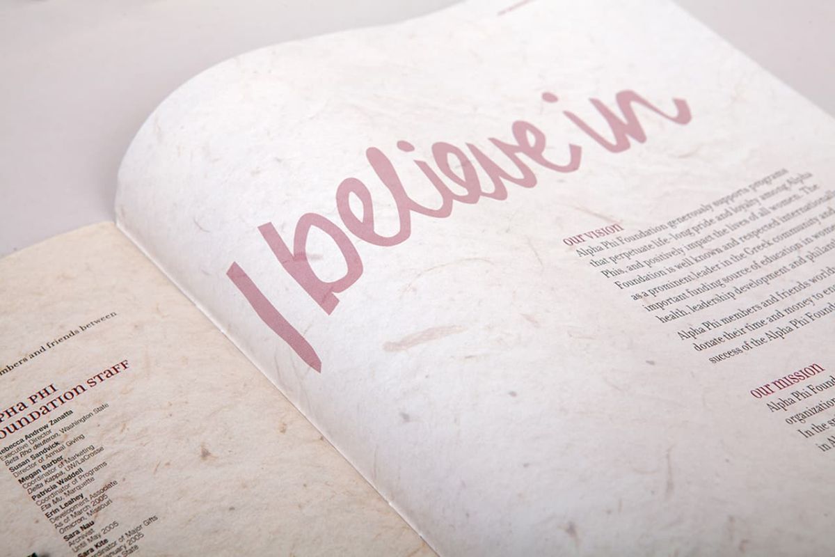a zoom of the left side of an open copy of the alpha phi annual report the page has a large header that says I believe in