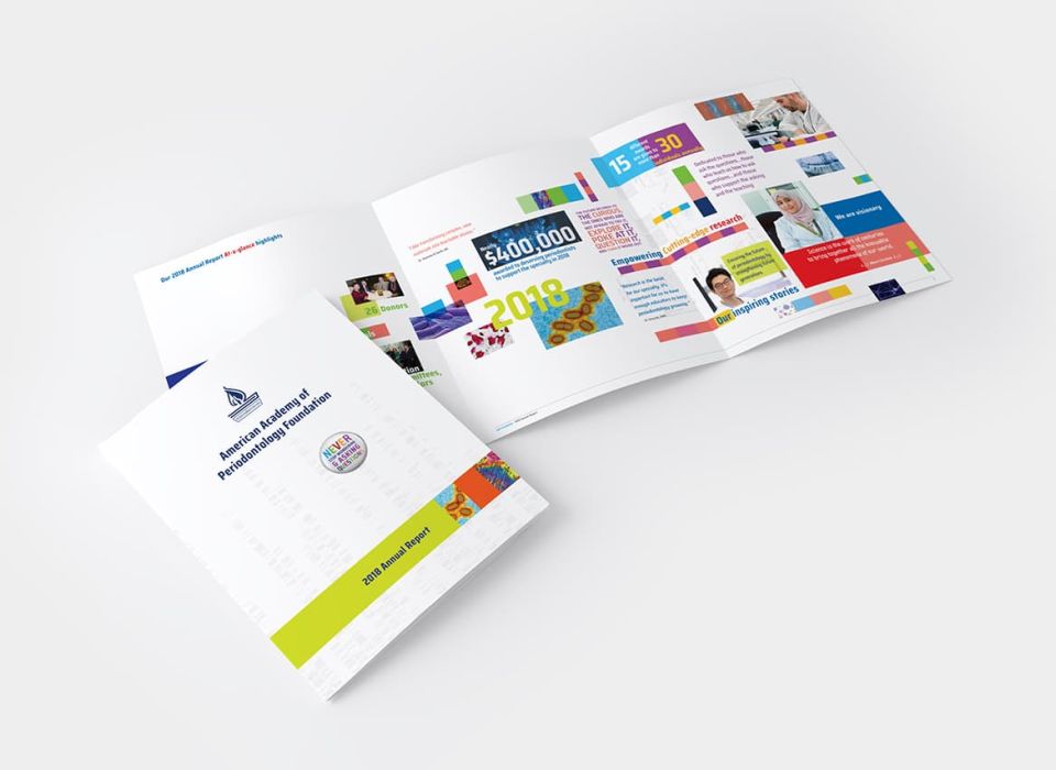 overhead view of multiple copies of the AAPF 2018 Annual Report showcasing NeigerDesign's printmaking integrated designs